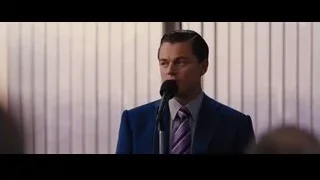 man speaking into microphone in room — The Wolf Of Wall Street