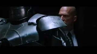 Bald man looking at robot in dark room — Iron Man