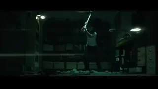 man swinging baseball bat in dark room — John Wick