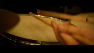 Hand playing snare drum with drumstick — Whiplash