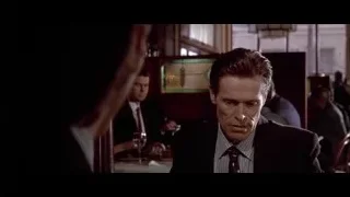 man in suit sitting in restaurant — American Psycho