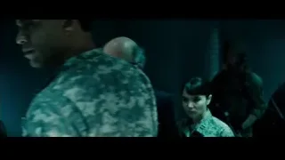 Bald man in suit standing in dark room — Superman: Man of Steel