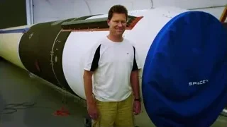 man standing in front of rocket engine — Elon Musk: Return to Space