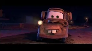 Mater standing on dirt road at night — Cars