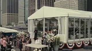 people gathered in white tent on rooftop — Succession