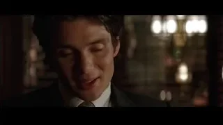man in suit and tie in dimly lit room — Batman