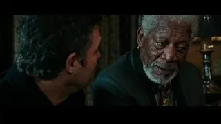 two men talking in dimly lit room — Now You See Me 2