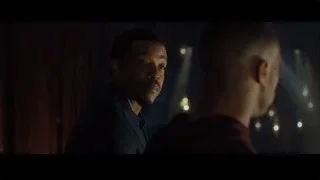 two men in suits in dimly lit room — Creed 2