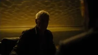 man sitting on couch in dim room — Blade Runner 2049