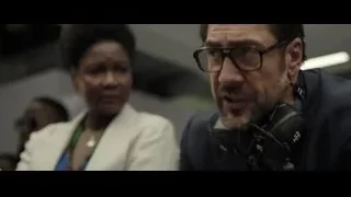 Man in suit speaking into microphone — F1