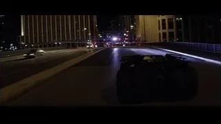 black car driving on city street at night — Batman