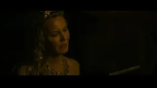 woman with gold headpiece looking at wooden object — Gladiator 2