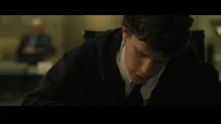 Young man in suit at office desk — The Social Network