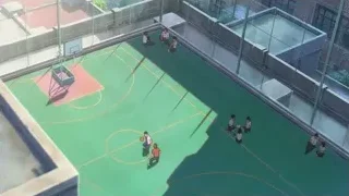 Rooftop basketball court with people playing — Your Name