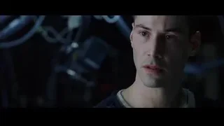 Young man's face in dimly lit room — The Matrix