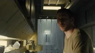 man deep in thought in dimly lit room — Blade Runner 2049