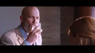 Bald man holding glass, woman attentive — Iron Man