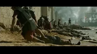 battle scene on beach with burning ship — Gladiator 2
