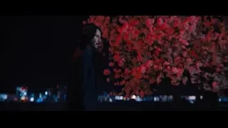man with beard by tree with red lights — John Wick: Chapter 4