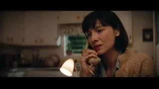 woman in kitchen talking on telephone — Ford v Ferrari