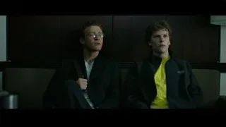 two young men sitting on a dimly lit couch — The Social Network
