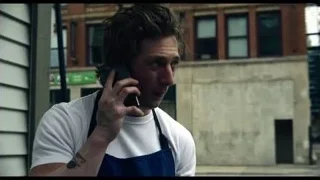 man talking on mobile phone on street — The Bear