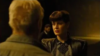 Woman in patterned jacket in dim room — Blade Runner 2049