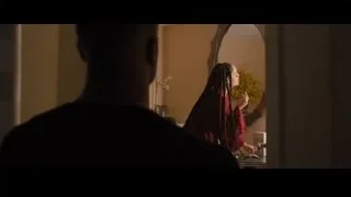 woman looking at reflection in bathroom — Creed 2