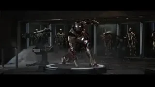 man repairing car in workshop — Iron Man 3