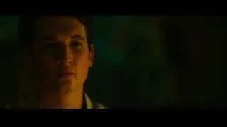 young man with serious expression in green light — Whiplash