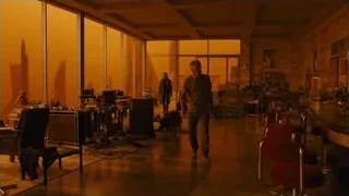 man holding dog in large room with windows — Blade Runner 2049