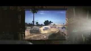 Large screen displaying cars on dirt track — Cars 3