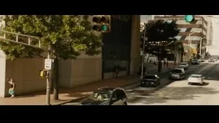 black car driving fast on city street — Furious Seven