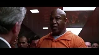 man in orange prison uniform in hallway — Batman: The Dark Knight