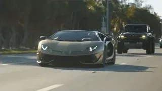 black Lamborghini driving fast on highway — Sports Cars