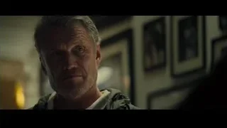 man standing in front of framed pictures — Creed 2