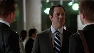 three men in suits talking with green lights — Suits