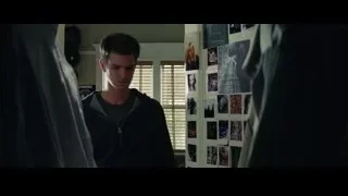 young man in hoodie by wall of photos — The Amazing Spider Man 2