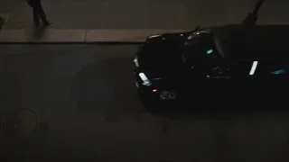 Black limousine parked on street at night — Succession