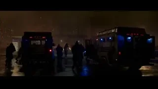 People around armored police vehicles at night — Spiderman: No Way Home