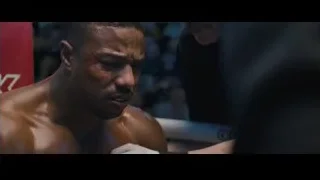 Elderly man in blue lit room — Creed 2