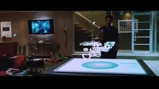 man holding futuristic weapon in room — Iron Man