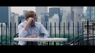 man sitting on balcony with city view — The Big Short
