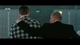 two men talking in room with green wall — Now You See Me 2