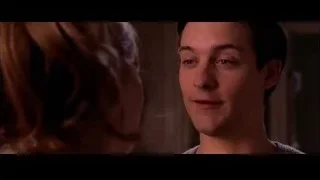man looking down at woman in dimly lit room — Spider Man 2