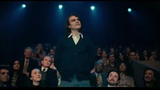 Man on stage with large crowd — Joker