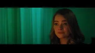 Young woman looking serious by green curtain — La La Land