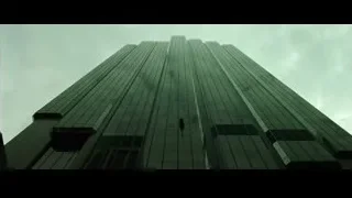 Skyscraper with cross under cloudy sky — The Matrix
