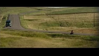 person riding motorcycle on winding road — Into the Wild