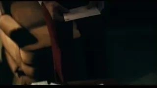 man in dimly lit room holding tablet — Joker